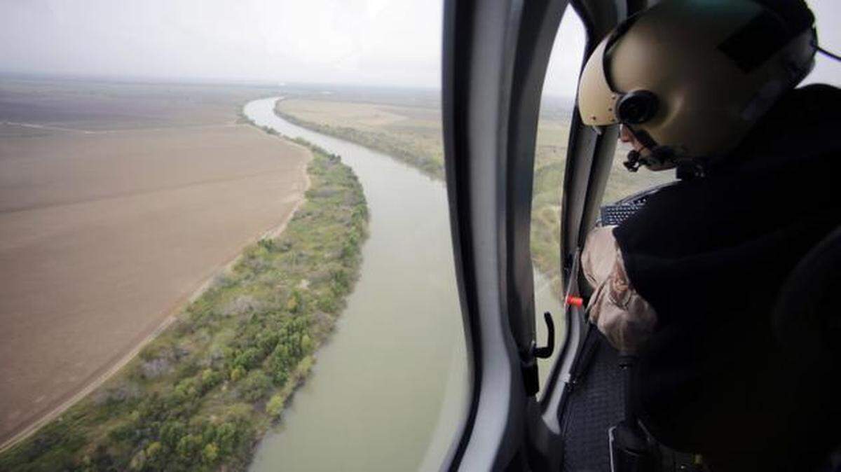 
A U.S. Customs and Border Protection air and marine agent looks at the Rio Grande on the Texas-Mexico border. 
