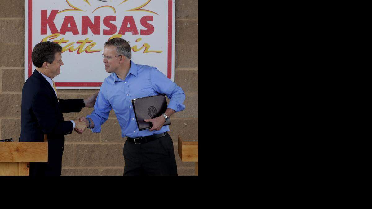 
Gov. Sam Brownback, left, and challenger Paul Davis shake hands after Saturday’s debate.
