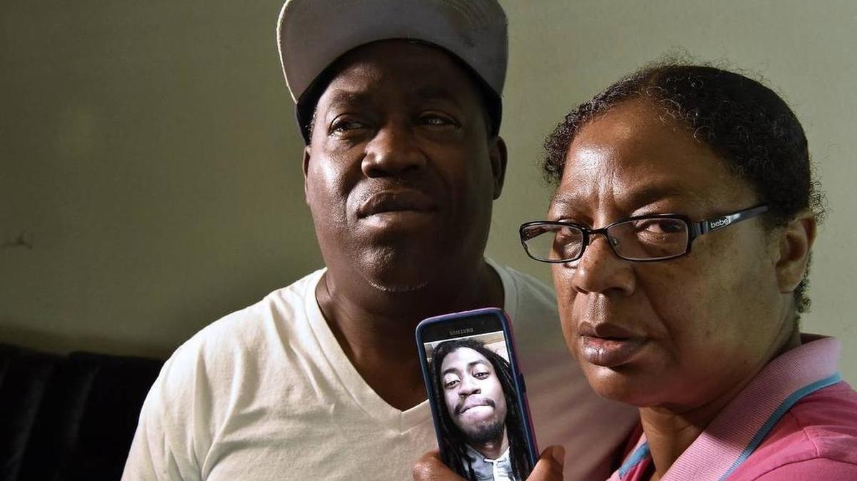 Anthony Belton Sr. and Donna Belton with a photo of Anthony A. Belton Jr.