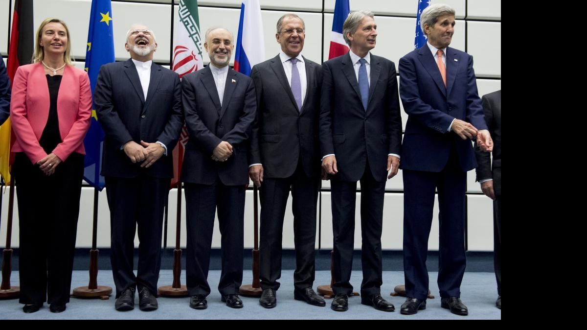 
U.S. Secretary of State John Kerry and negotiating partners share a light moment after reaching a deal on Iran.
