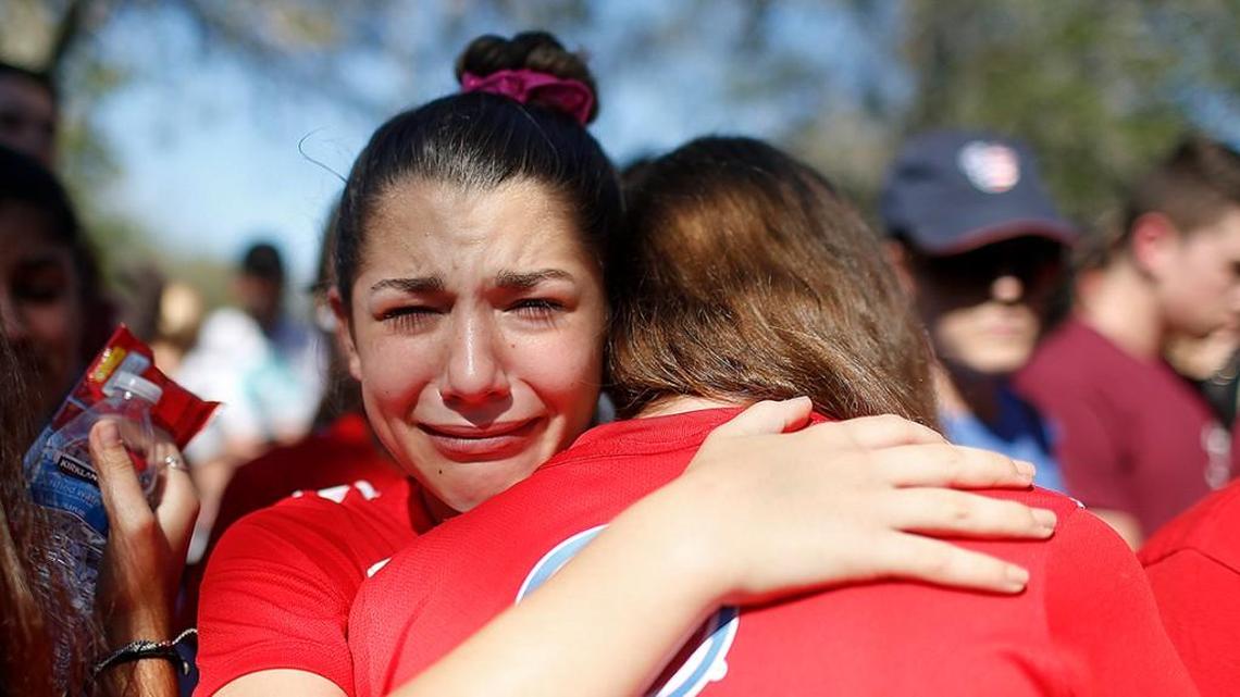 A student mourns the loss of her friend during a community vigil in Parkland, Fla., for the victims of the shooting at Marjory Stoneman Douglas High School.