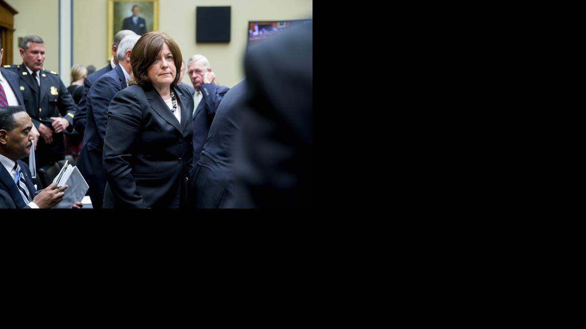 
Julia Pierson, director of the U.S. Secret Service, leaves a House committee hearing, where she answered questions about agency lapses.
