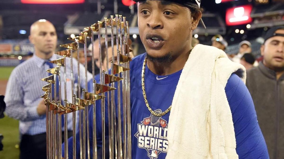 Kansas City Royals starting pitcher Edinson Volquez held the World Series trophy after the Royals defeated the New York Mets.