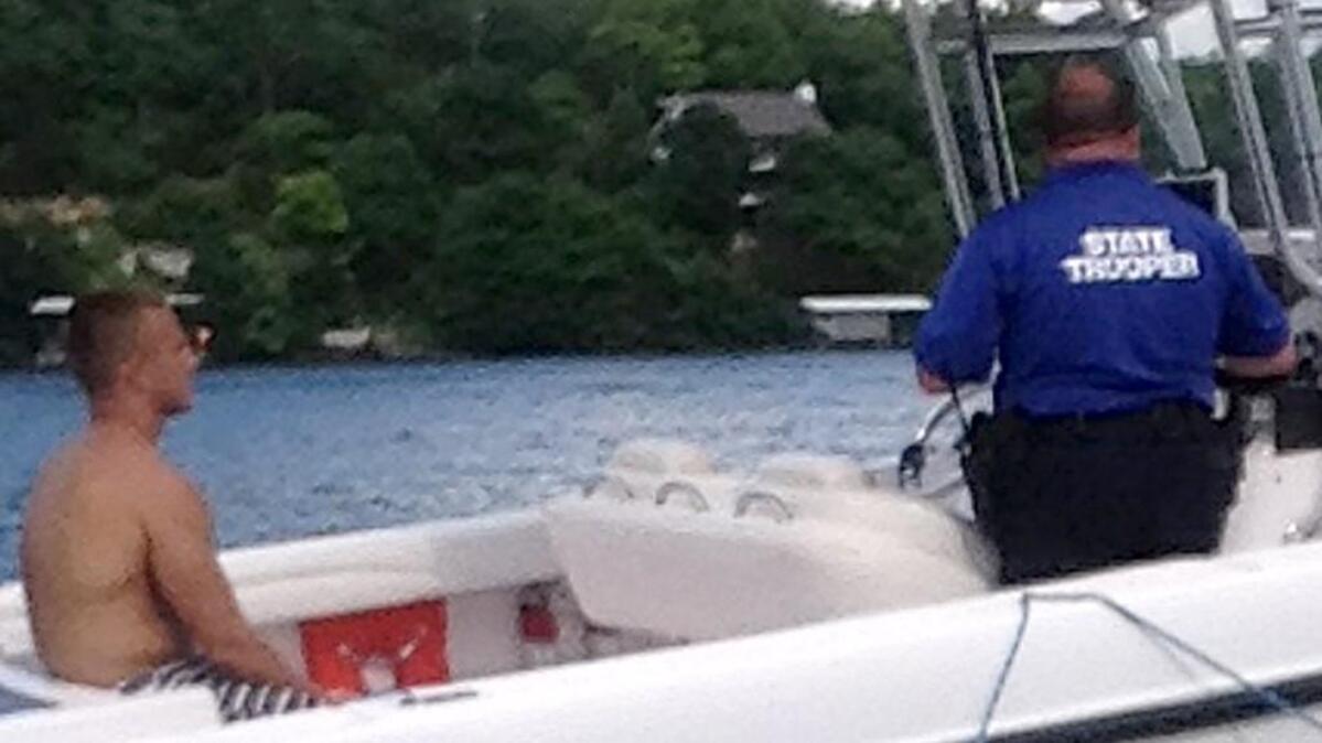 This photo by Myles Goertz shows Brandon Ellingson in the back of Trooper Anthony Piercy’s boat on May 31, 2014.
