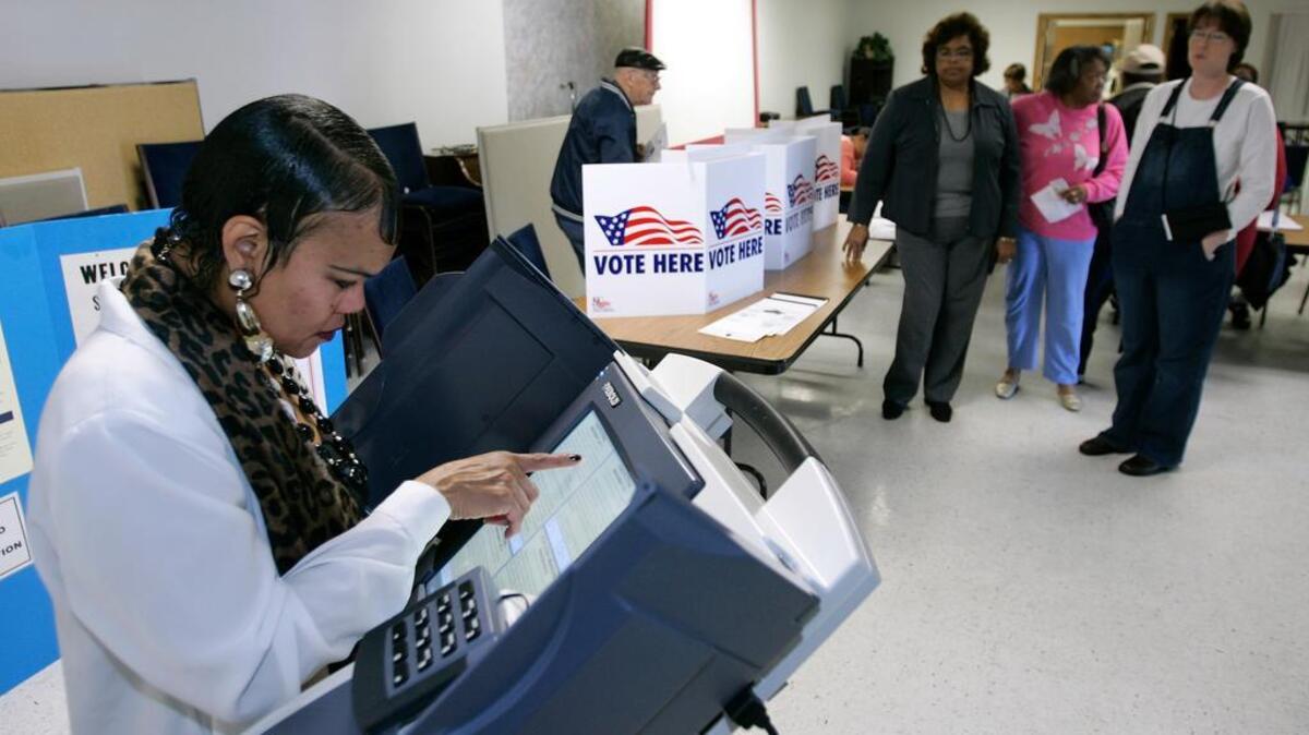 A voter uses a touch-screen voting machine.