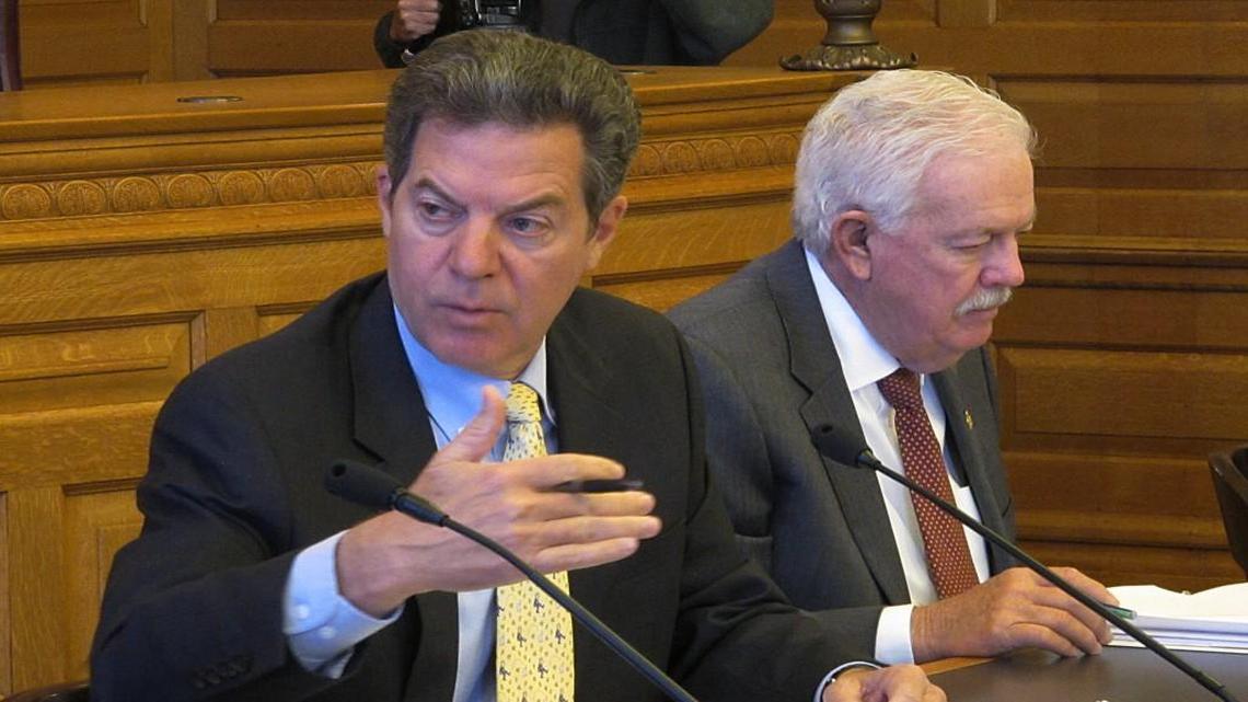 Purging lawmakers who offer dissenting views is a tactic used by Gov. Sam Brownback of Kansas (left) and House Speaker Ray Merrick.