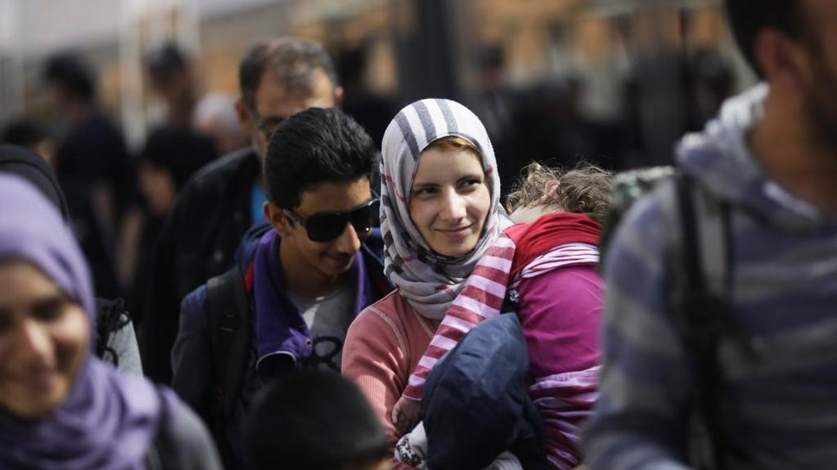 
A woman with a baby arrives Tuesday with other refugees at the train station in Passau, Germany.
