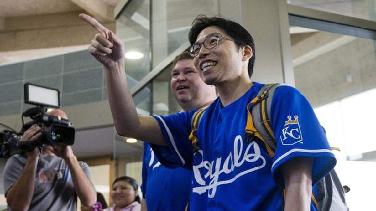
SungWoo Lee, a major Royals fan from Korea, acknowledges his welcoming party at KCI.
