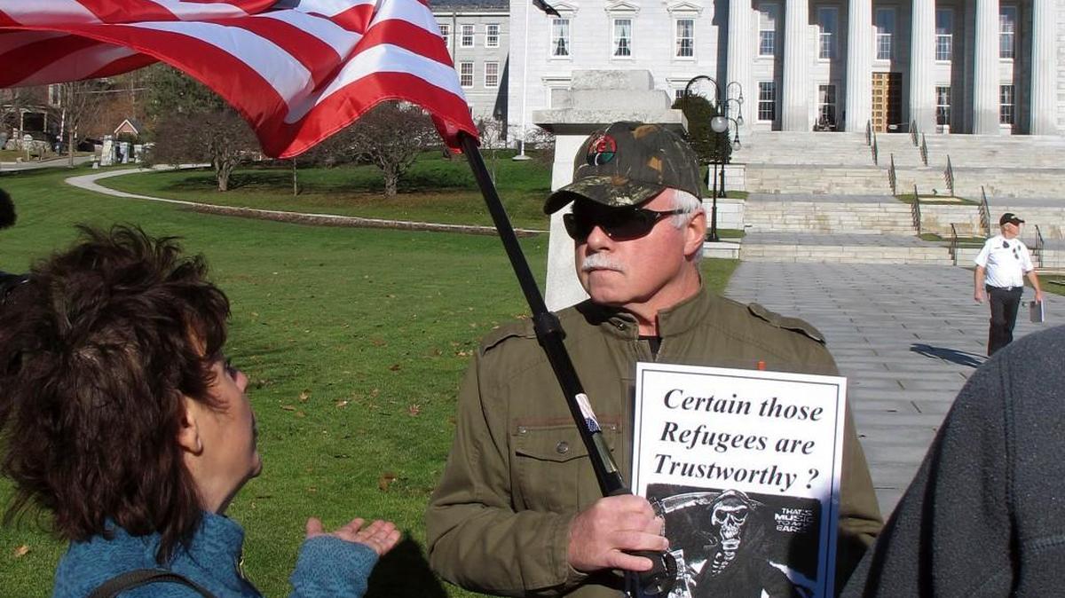 Bronwyn Fryer (left) and Rick Lawrence on Friday debated whether Syrian refugees should be brought to the state. Fryer favored giving refuge on humanitarian grounds; Lawrence was opposed for financial and security reasons.