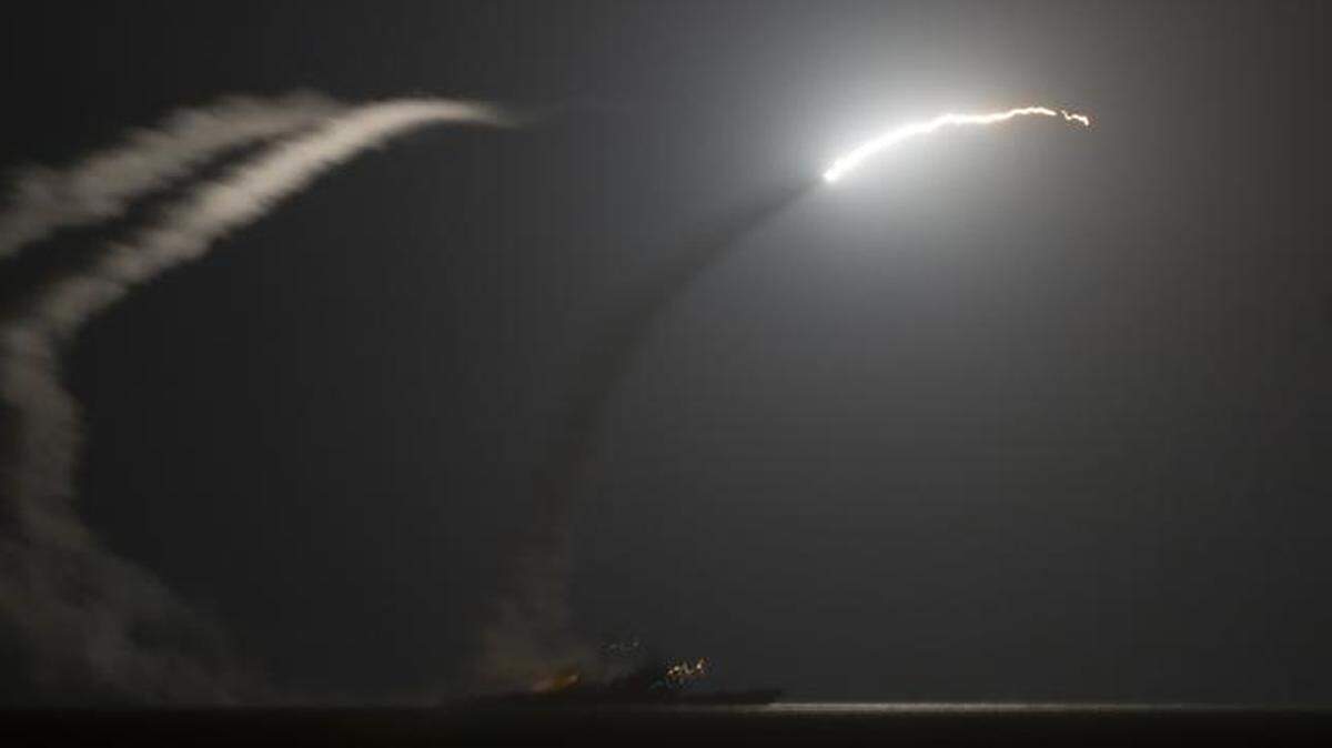 
The guided-missile cruiser USS Philippine Sea launches a Tomahawk cruise missile toward a target in Syria.
