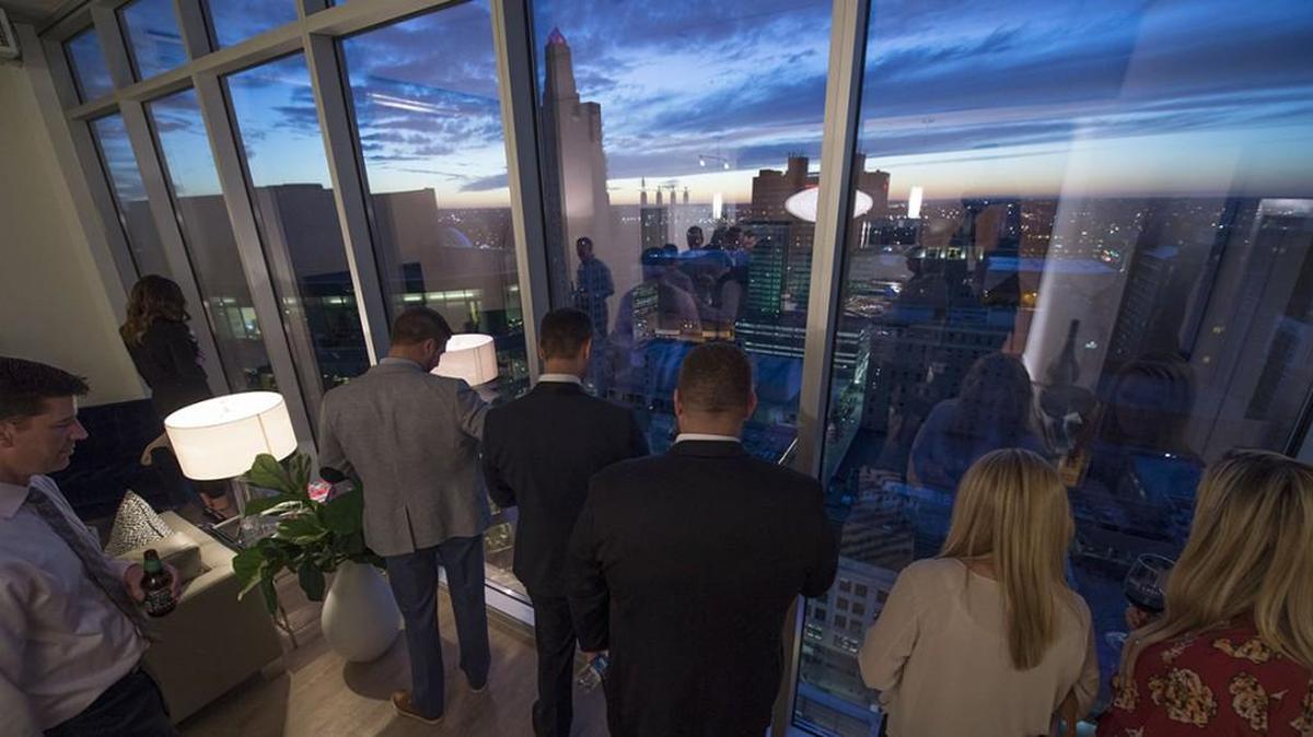 People paused to admire the view of downtown from one of the penthouses on the 26th floor at the One Light apartment building in December 2015.