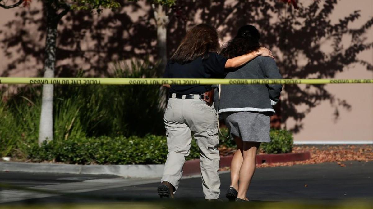 An unidentified woman was comforted Tuesday by an investigator at the Inland Regional Center, the site of last week’s shooting rampage that killed 14 people in San Bernardino, Calif.