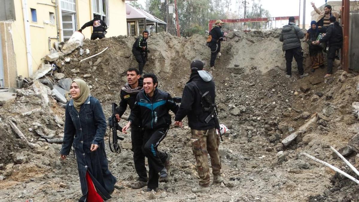 Iraqi security forces and Sunni tribal fighters helped trapped civilians cross out of neighborhoods under Islamic State group control in Ramadi in early 2106.