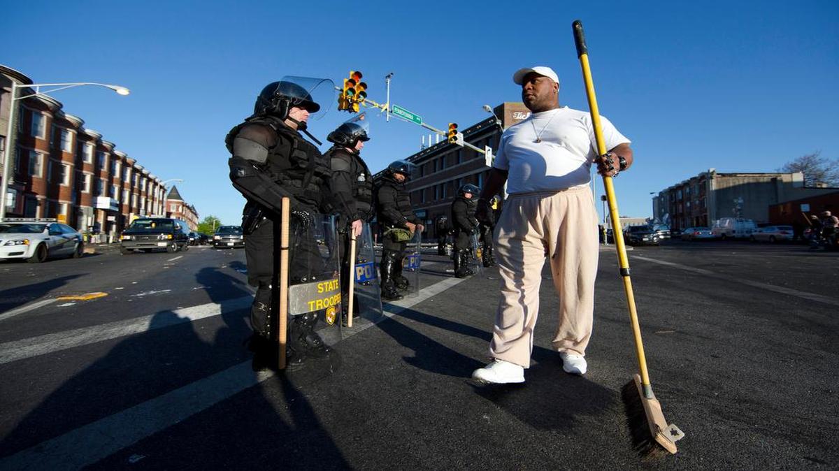 
Victor Huntley-el thanked law enforcement officers Tuesday as he cleaned part of a Baltimore neighborhood.
