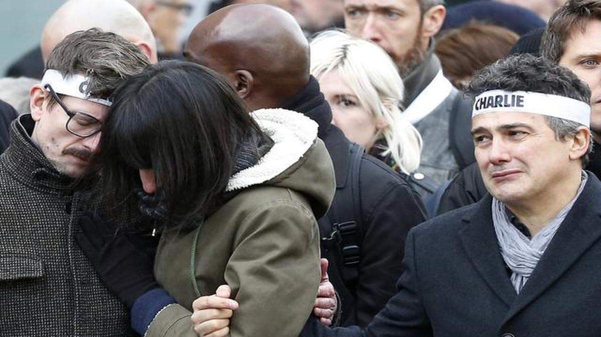 
Charlie Hebdo newspaper staff members grieved Sunday during a rally in Paris.

