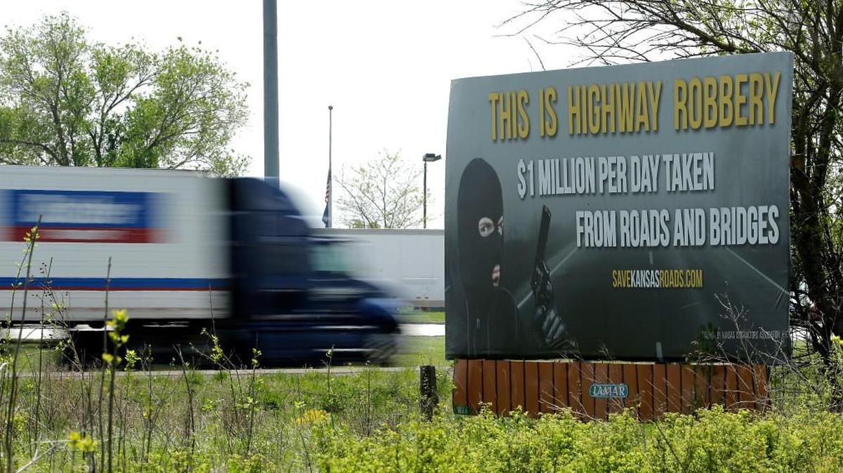 A billboard on the Kansas Turnpike criticizes Gov. Sam Brownback’s decision to divert highway funds and delay improvement projects.
