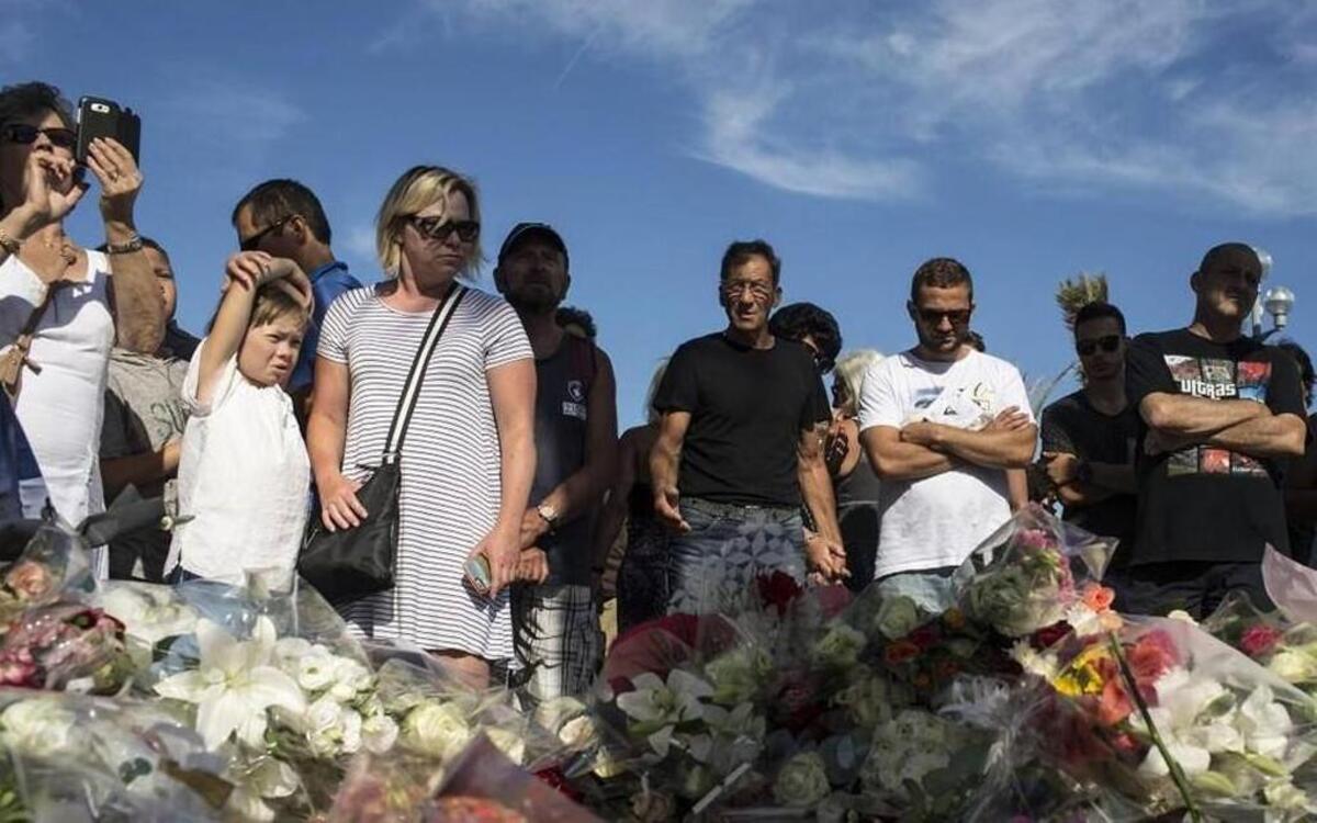 People stood near a makeshift memorial for the victims killed in an attack where a truck last week mowed through revelers in Nice, France.