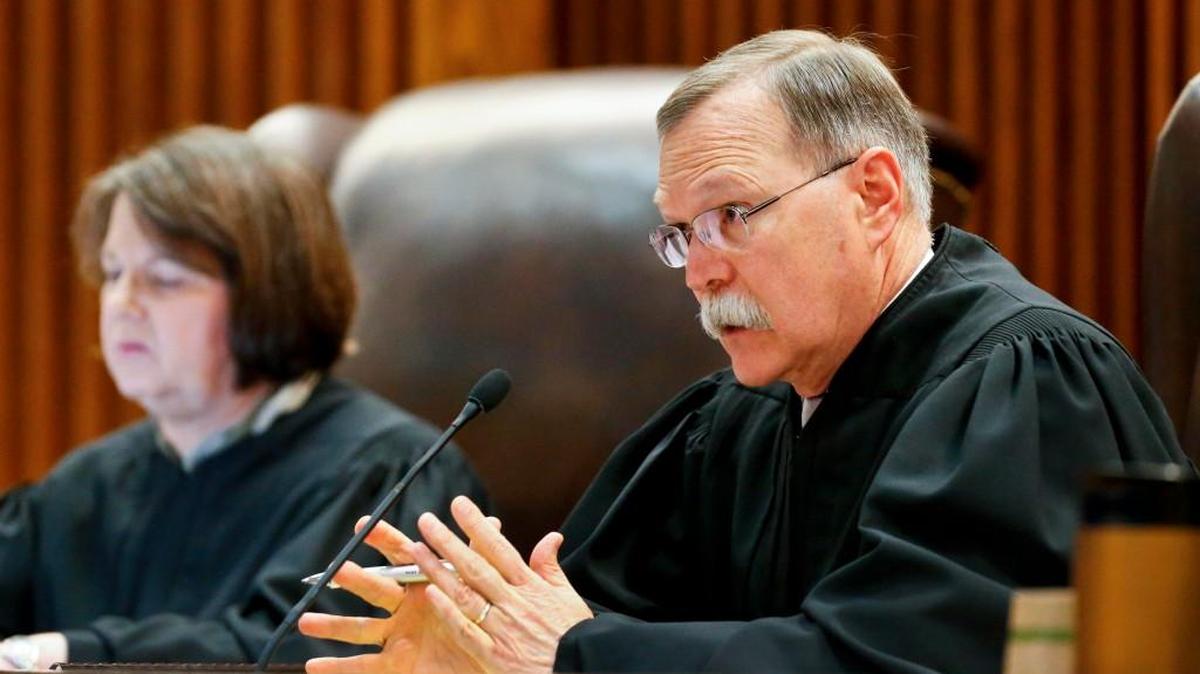 Kansas Supreme Court Chief Justice Lawton Nuss (right) questioned lawyers during a school funding hearing in 2016.