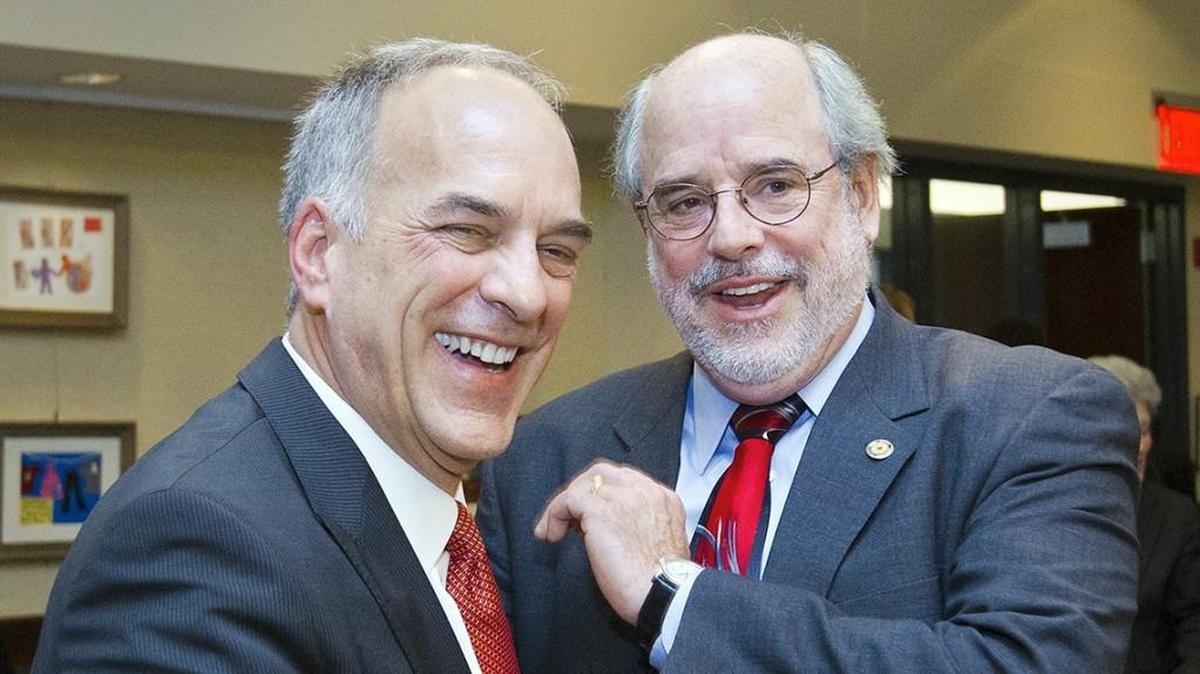 In this January 2013 photo Steve Klika (left) is congratulated by Johnson County Manager Hannes Zacharias after Klika was sworn in as commissioner of the third district. Klika was one of four commissioners who voted not to renew Zacharias’ contract earlier this month.