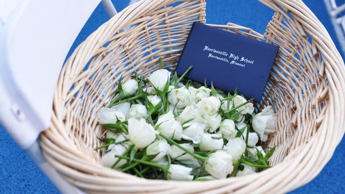 Harrisonville High’s Class of 2014 placed white roses in the empty chair memorializing their classmate Katie Rios, who was stabbed to death by her cousin four years earlier.