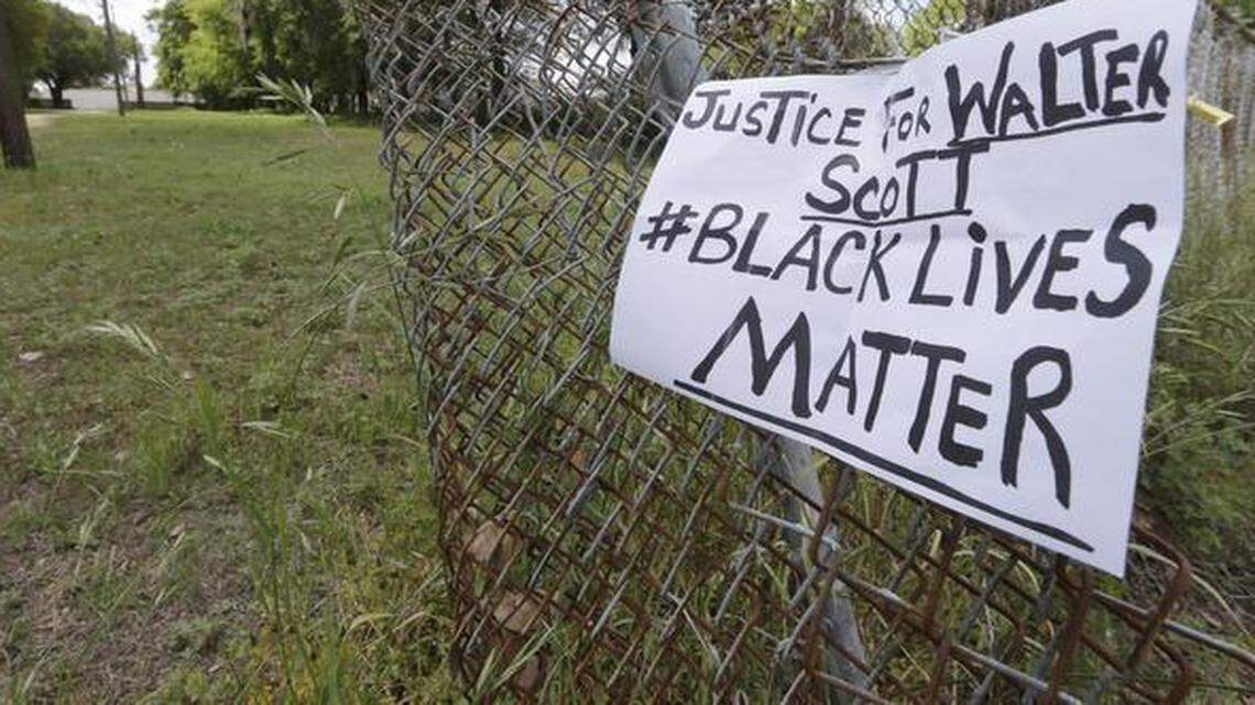 
A sign calling for justice Wednesday was attached to a fence near the site where Walter L. Scott was killed in North Charleston, S.C. Scott was killed by a North Charleston police officer after a traffic stop on Saturday. The officer, Michael T. Slager, has been charged in the slaying.
