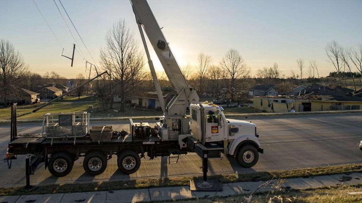Work crews like those in Oak Grove Tuesday make it possible for the Kansas City area to recover from storm damage.