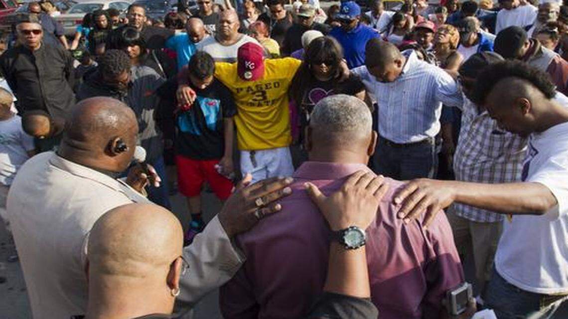 
People prayed at the start of a vigil for shooting victims Ka'Vyea Curry, who was killed April 21 by a gunman at a gas station on Cleveland Avenue in Kansas City, and his 10-year-old son Ka'Vyea Tyson, who was critically injured.

