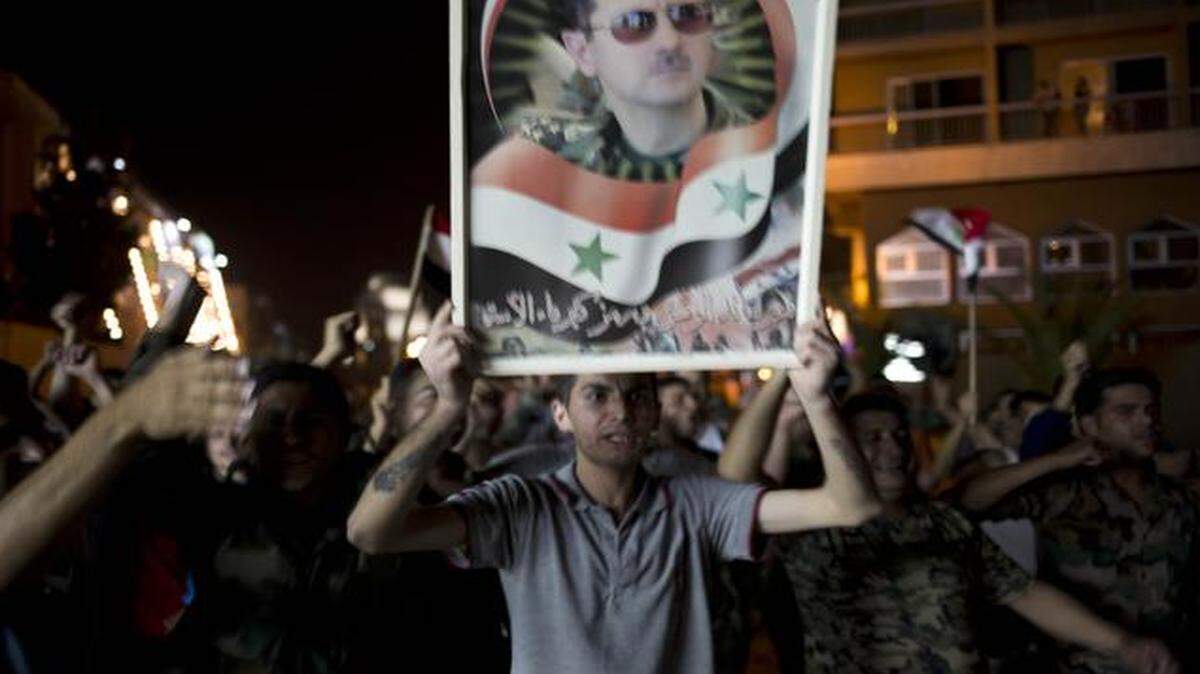 
Syrian soldiers celebrate Bashar Assad's presidential re-election in Damascus, Syria.
