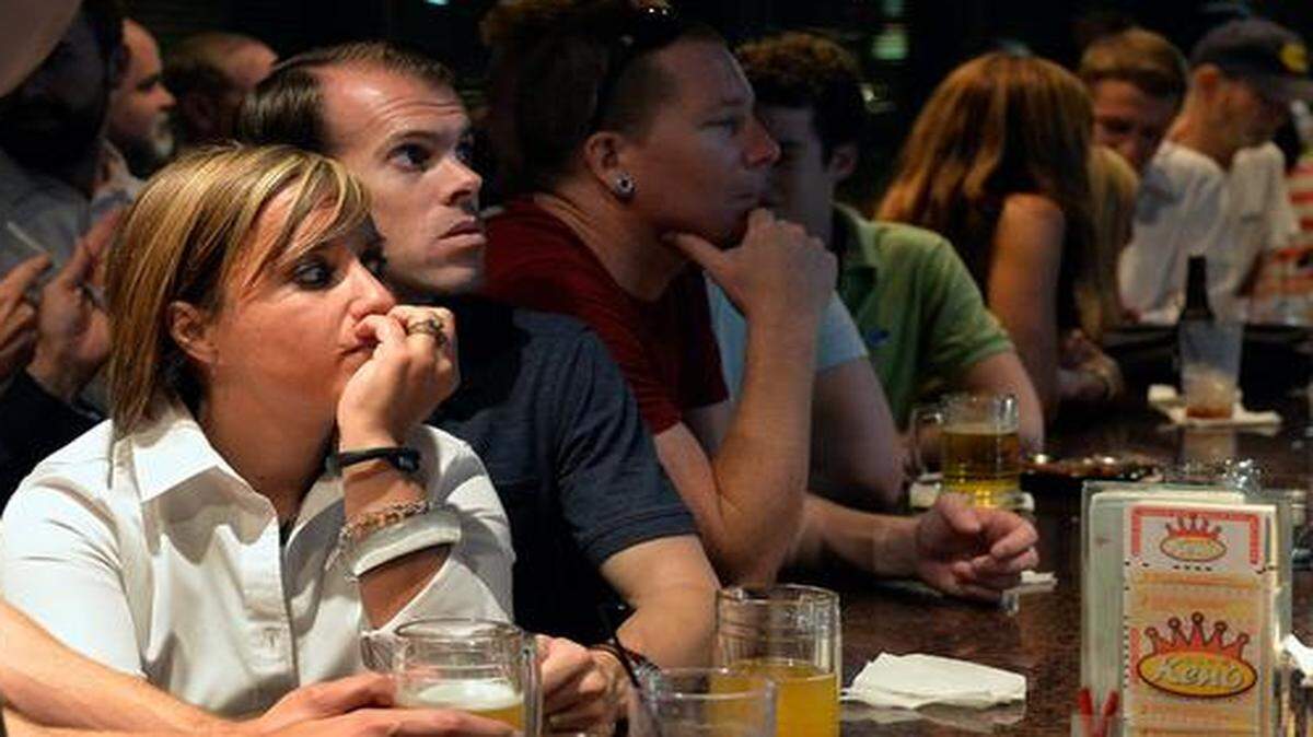 
Katie and Jared Campbell (center) of Kansas City watched election returns with supporters of Question A, the streetcar expansion proposal which went down to defeat Tuesday. 
