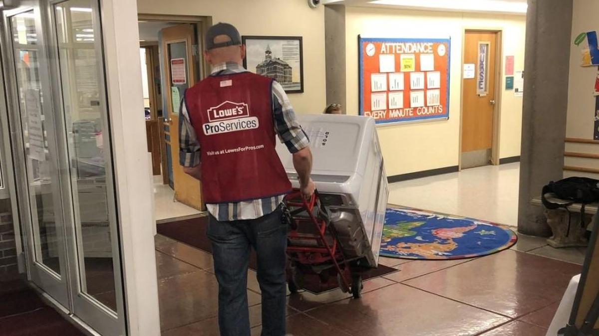 A worker from Lowe’s delivers a dryer to Garfield Elementary School as part of United Way of Greater Kansas City’s Loads of Love program.