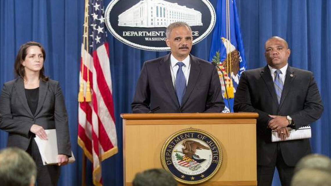 
Attorney General Eric Holder, center, accompanied by Acting Assistant Attorney General for Civil Rights Division Molly Moran, left, and Ronald Davis, director of the Office of Community Oriented Policing Services (COPS), speaks during a news conference Thursday at the Justice Department in Washington, announcing the Justice Department's civil rights division will launch a broad civil rights investigation of the Ferguson, Mo., Police Department. 

