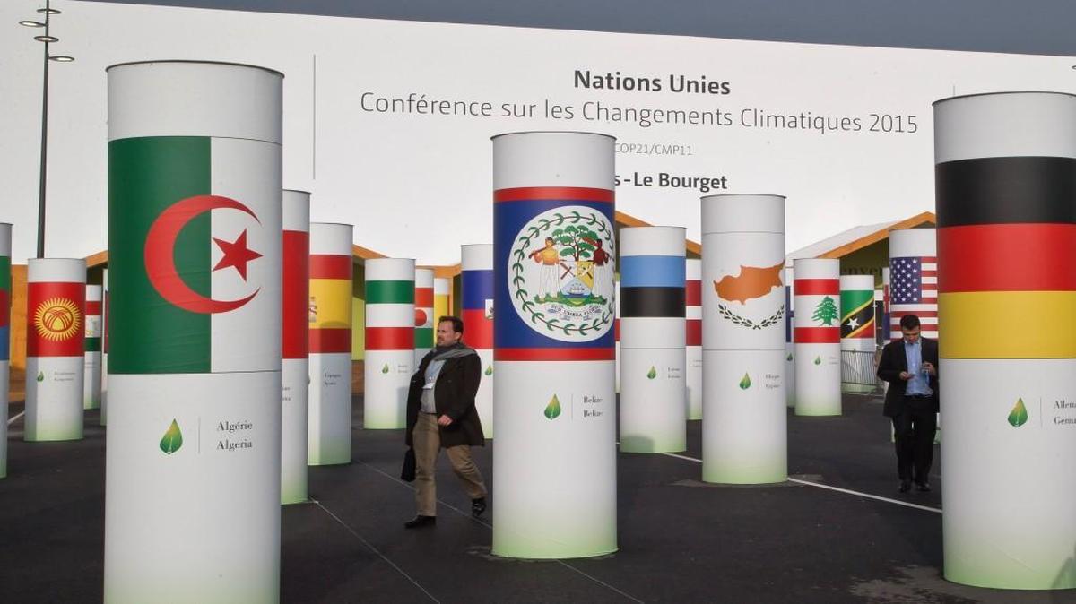 Delegates walked outside the main entrance of the United Nations climate change conference outside Paris.