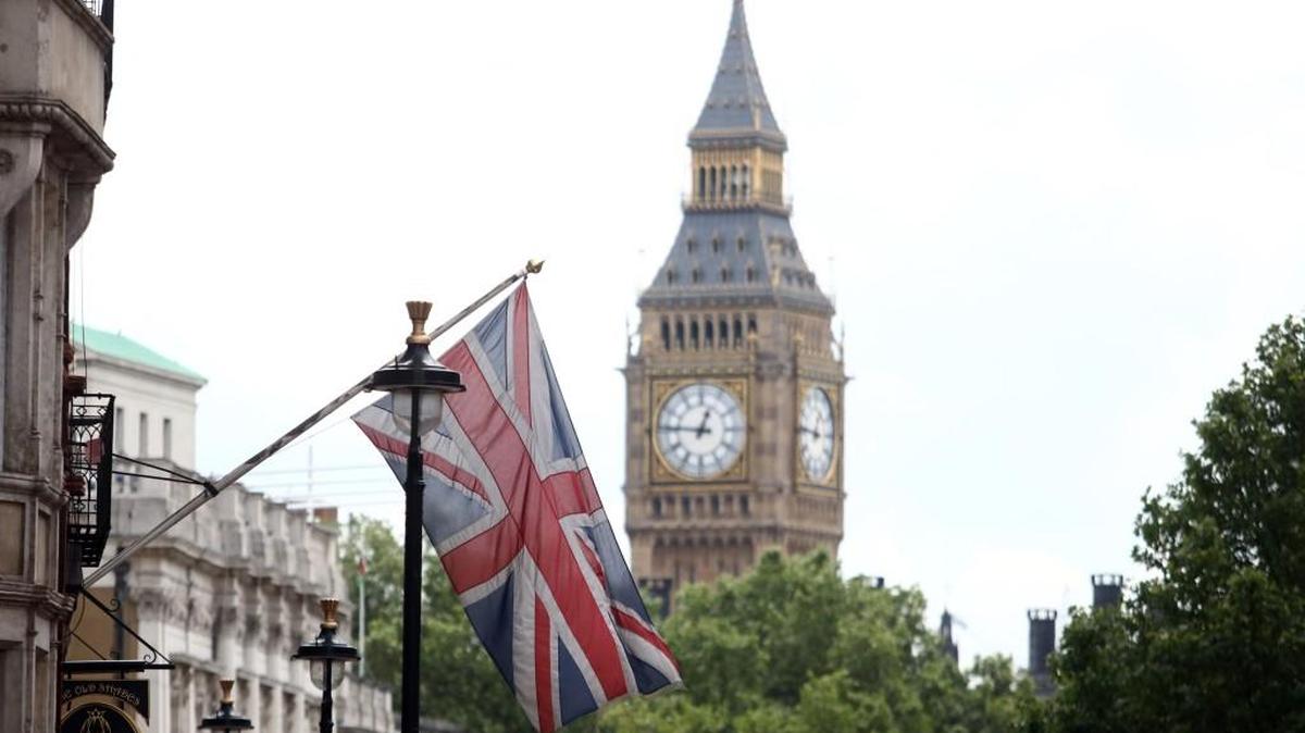 A British Union flag hangs against a backdrop of Big Ben in London.