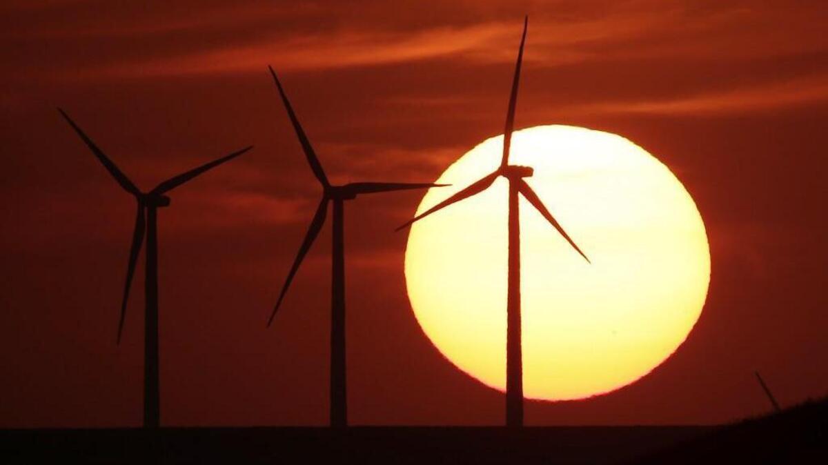 Wind turbines are silhouetted by the setting sun as they produce electricity near Beaumont, Kan. This Earth Day, which is next Friday, people will think more about the plains of Kansas and how the area could be a treasure trove in the nation’s growing effort to harness clean energy.