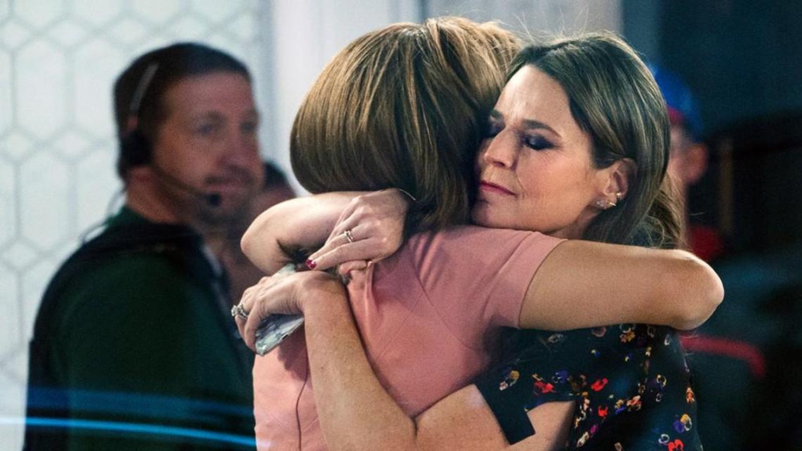 Co-anchors Hoda Kotb, left, and Savannah Guthrie embrace on the set of the “Today” show Wednesday after NBC News fired host Matt Lauer for “inappropriate sexual behavior.”