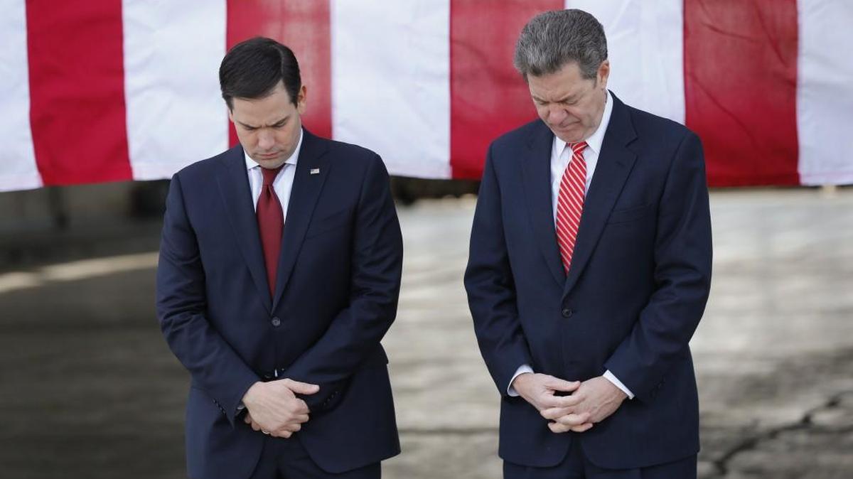 Republican presidential candidate Sen. Marco Rubio of Florida and Gov. Sam Brownback of Kansas prayed at a campaign rally Friday in Topeka.