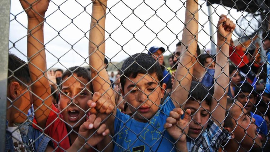Syrian refugee children chanted slogans behind a fence at the Nizip refugee camp in Gaziantep province, southeastern Turkey, after an April visit by German Chancellor Angela Merkel and top European Union officials. Merkel and the officials, under pressure to reassess a migrant deportation deal with Turkey, were traveling close to Turkey's border with Syria in a bid to bolster the troubled agreement.