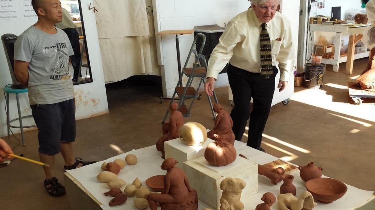 
Tony Jones (right), interim president of the Kansas City Art Institute, visited with a ceramic artist from China, Bangmin Nong.
