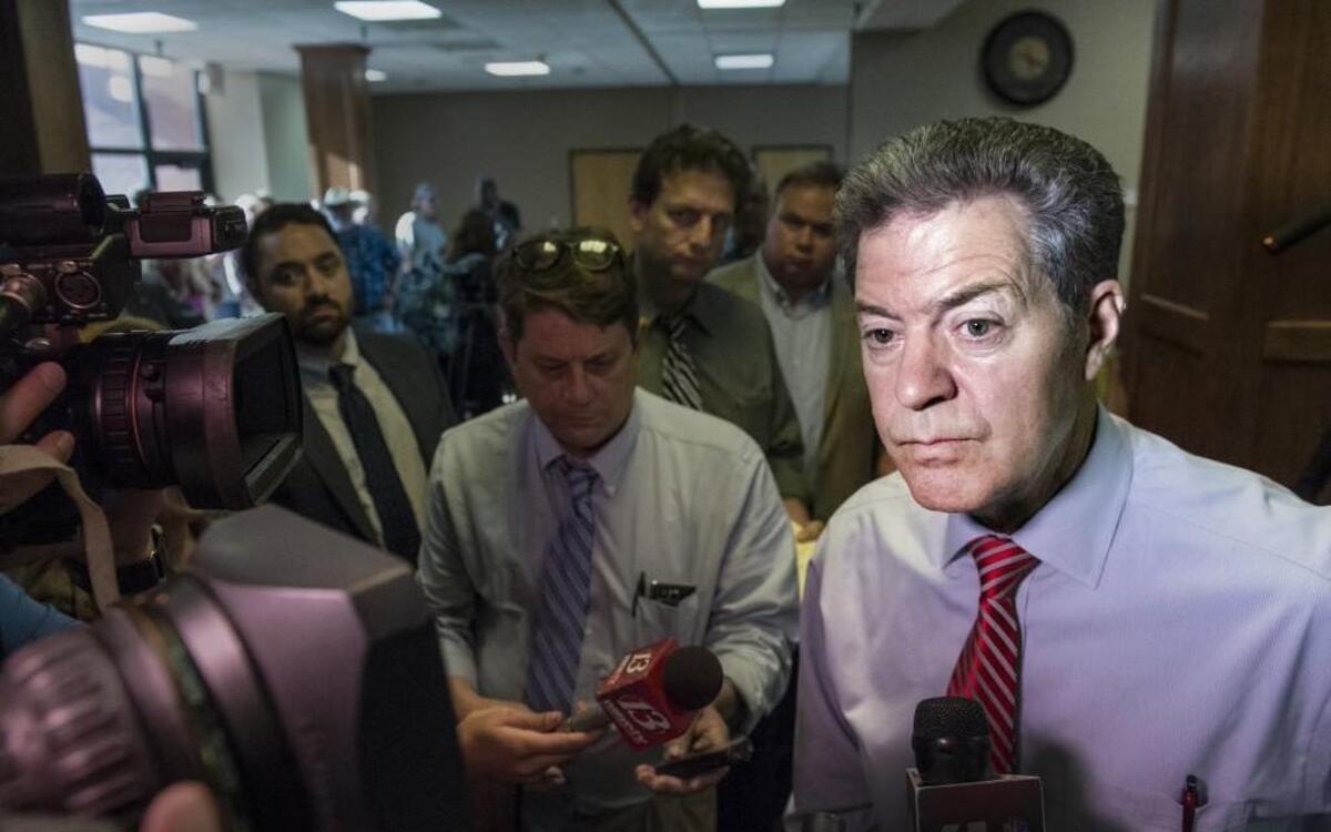Kansans and Gov. Sam Brownback, shown here at a meeting earlier this year, got some more bad news Friday about the state’s financial ills.
