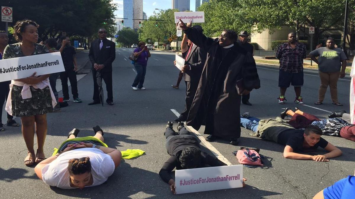 
Protesters lay in the middle of a Charlotte, N.C., street to protest the mistrial in the case of a Charlotte-Mecklenburg police officer accused of killing an unarmed man, Jonathan Ferrell, two years ago.
