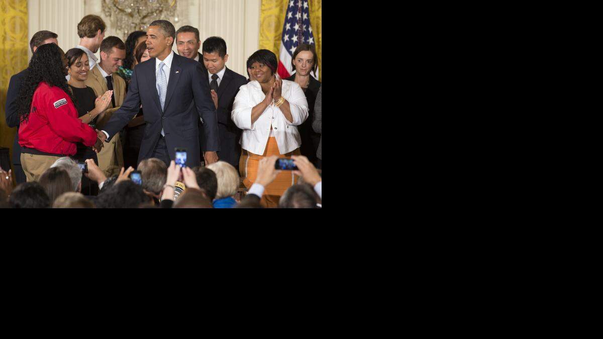 President Obama signs an order to relieve some student debt burden. <252><137>on reducing the burden of student loan debt, Monday, June 9, 2014, in the East Room of the White House in Washington. The president said the rising costs of college have left America's middle class feeling trapped. He says no hard-working youngster in America should be priced out of a higher education. Obama signed a presidential memorandum he says could help an additional 5 million borrowers. (AP Photo/Jacquelyn Martin)<252><137>