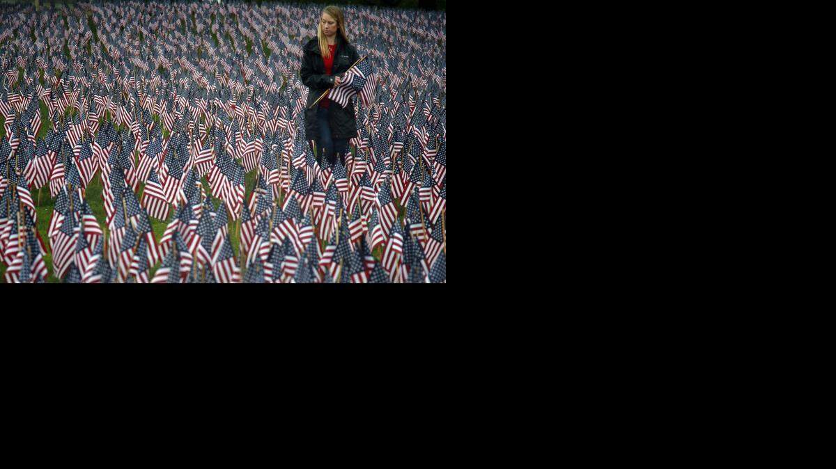 
Shannon Day last week inspected some of the 37,000 flags at the Boston Common in memory of fallen service members from the Revolutionary War to the present. 
