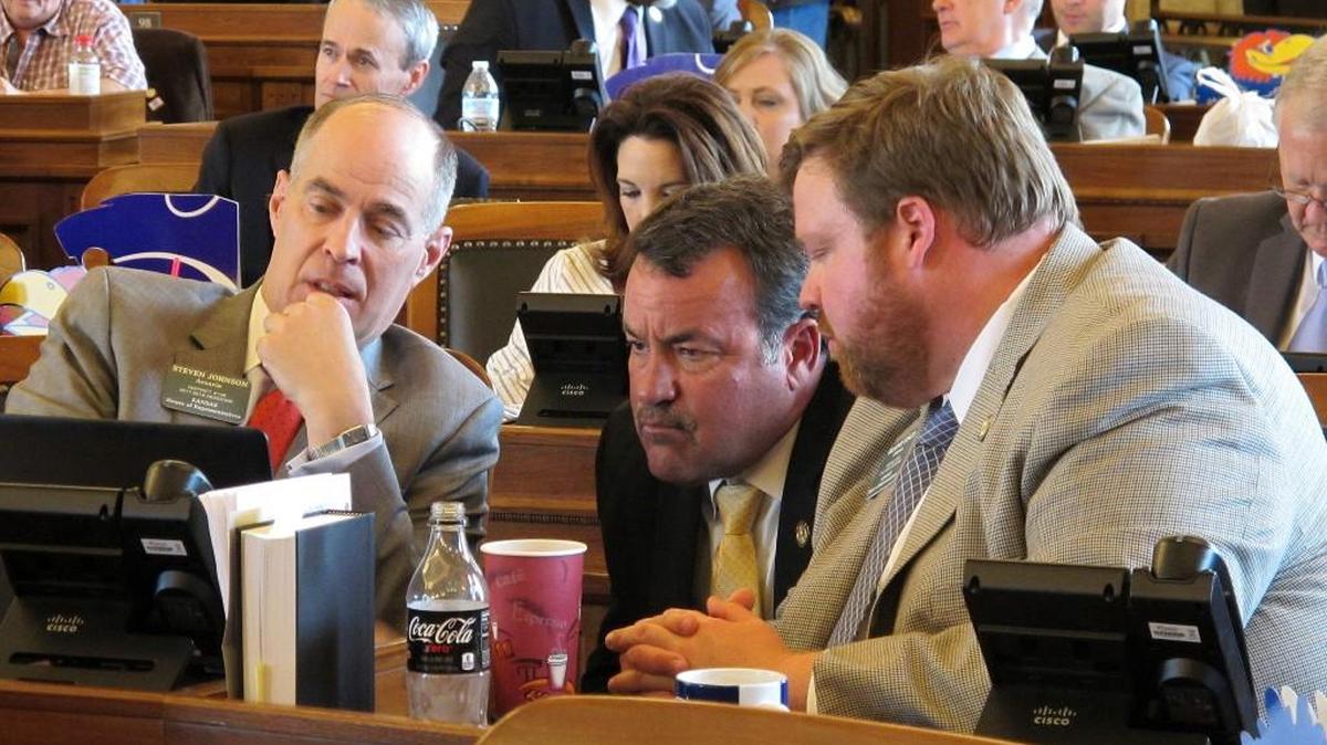 Kansas House Taxation Committee Chairman Steven Johnson, left, R-Assaria, confers with Reps. Kent Thompson, R-Iola, and Blaine Finch, right, R-Ottawa, during the House's session, Wednesday, May 31, 2017, at the Statehouse in Topeka, Kan.