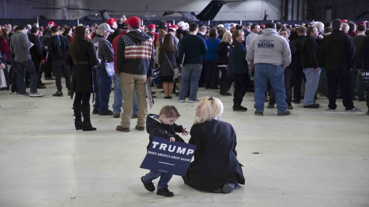 Jennifer Owens and her son Brady wait for the arrival of Republican presidential candidate Donald Trump ahead of a campaign stop Tuesday at an airport in Columbus, Ohio.