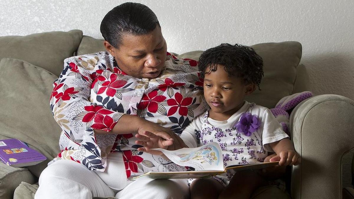 
Elisha Sims (left) at the 2013 start of the Dolly Parton's Imagination Library read, “The Little Train That Could,” to her then-3-year-old daughter, Katelyn, at their home in Kansas City. The United Way of Greater Kansas City program strives to get books in the hands of young children and encourage reading. It reached a milestone of having more than 1,000 area preschoolers enrolled.
