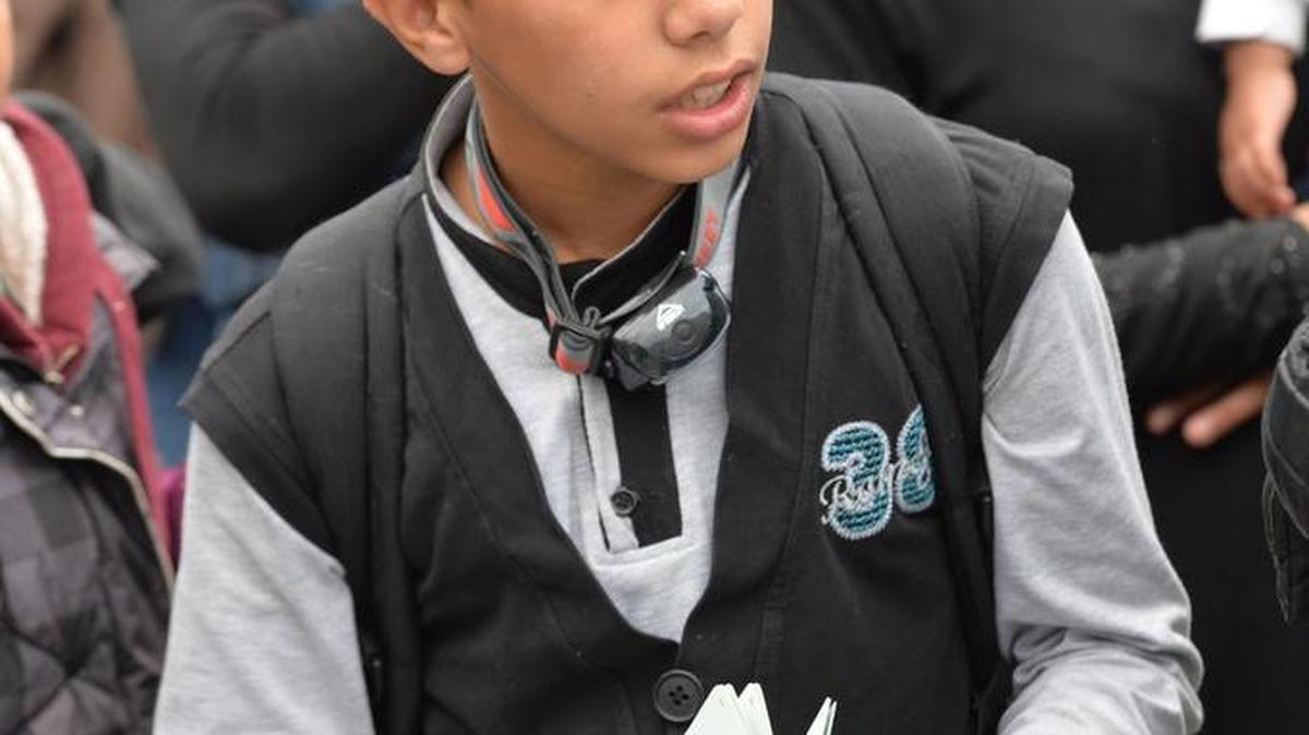 
A young refugee holds his passport as he tries to get into Germany.
