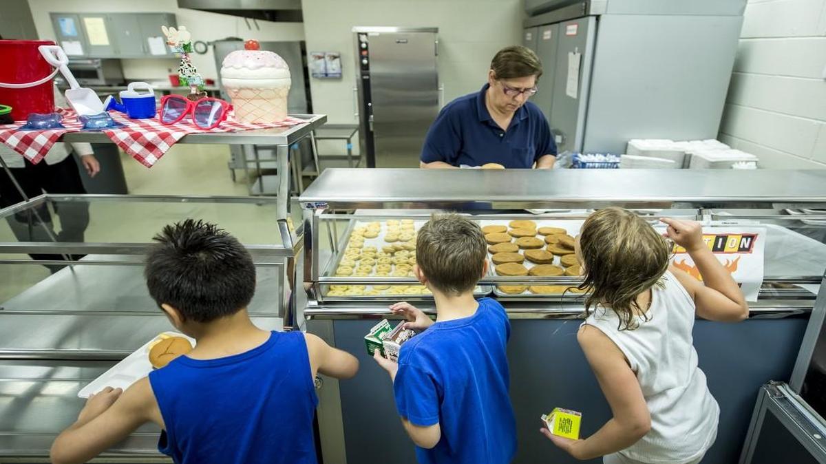 Children wait in line for food from Annamarie Manzo, top center, for a free school lunch at Overland Park Elementary School during a U.S. Department of Agriculture Summer Meals free lunch program for children, ages 1-18. The Shawnee Mission School District opened up several schools for the program to address summer hunger. A 2016 Annie E. Casey Foundation Kids Count report, however, shows Kansas has slipped in its national ranking in caring for children.