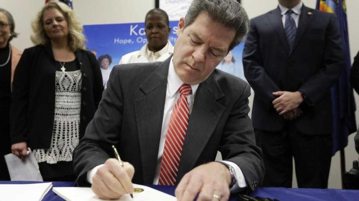 Gov. Sam Brownback last year signed a welfare reform bill into law in Topeka. Now he wants to create a mentor program for low-income people receiving state aid.