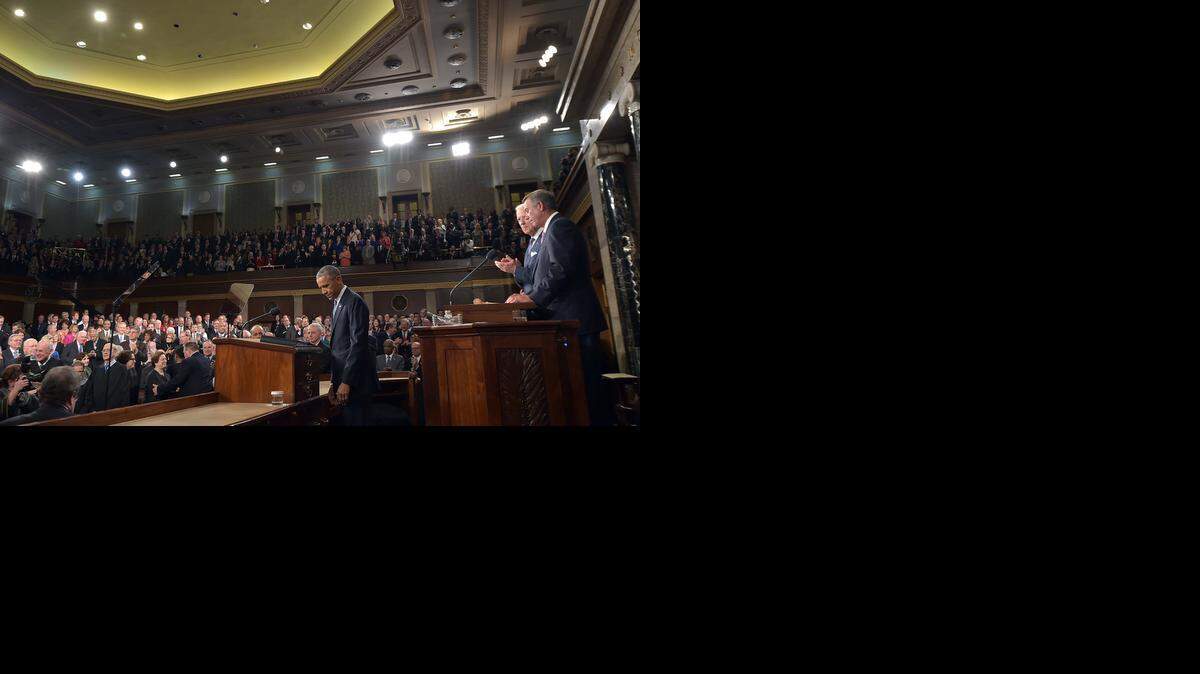 
President Barack Obama arrives to deliver his State of the Union address to a joint session of Congress on Capitol Hill on Tuesday, Jan. 20, 2015, in Washington. Vice President Joe Biden and House Speaker John Boehner of Ohio, are at right. 

