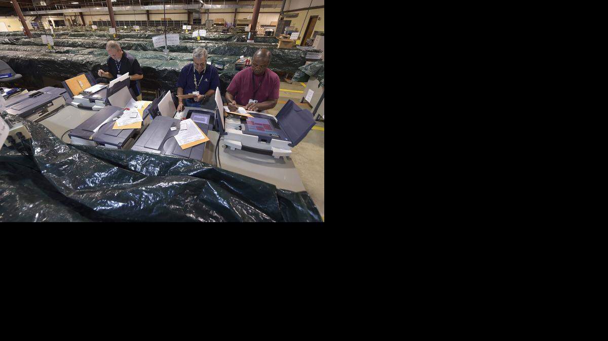 
Election machines, being unwrapped here by Johnson County election office workers, should be up and running in both Kansas and Missouri for important local and statewide races and ballot questions.
